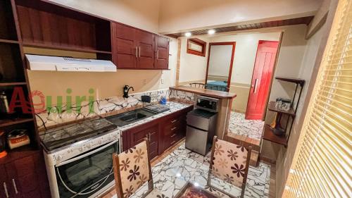 an overhead view of a kitchen with a stove top oven at Cómodo departamento en Cobija in Cobija