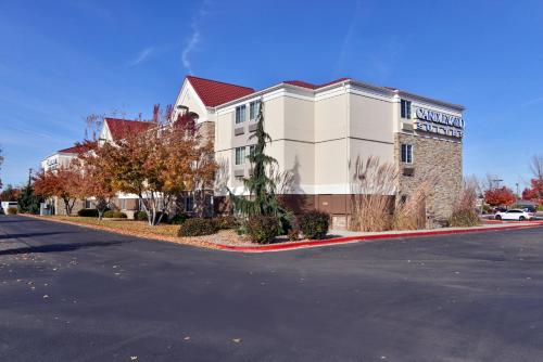 a building with a sign on the side of a street at Candlewood Suites Boise-Meridian by IHG in Meridian