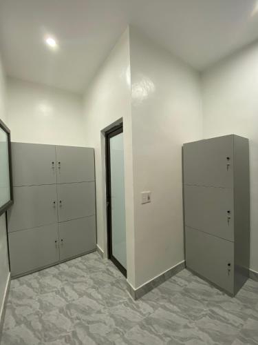 an empty room with three lockers and a mirror at Strawberry House , Tour & Motorbikes Rentel in Ha Giang