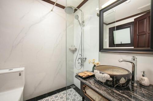 a bathroom with a sink and a shower at Media Central Hanoi Hotel - 108 Hàng Bạc - by Bay Luxury in Hanoi