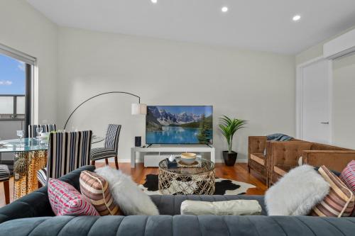 a living room with a couch and a table at Luxury Townhouse 7km close to the City in Braybrook