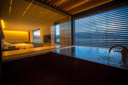 a hotel room with a large swimming pool with a bed at Hotel Kitanoya in Miyazu