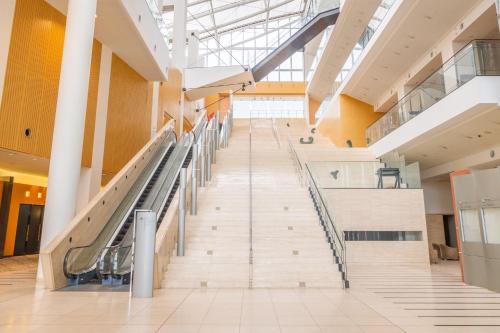a long staircase in a building with glass ceilings at Chateraise Hotel Nagano in Nagano