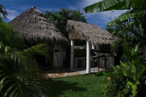 a small hut with a thatched roof at Casa MexiBali, Palapa Queen in La Majahua