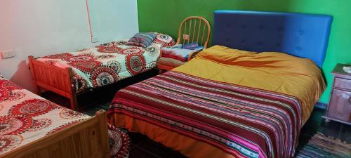 a bedroom with two beds and a blue head board at tranquilidad absoluta in Villa Unión