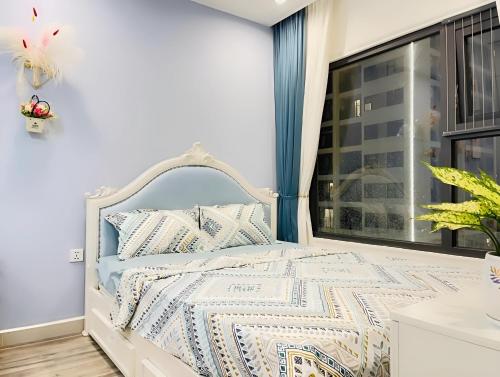a white bed in a room with a window at Homestay Vinhome Ocean Park - Pearl house S108 in Hanoi