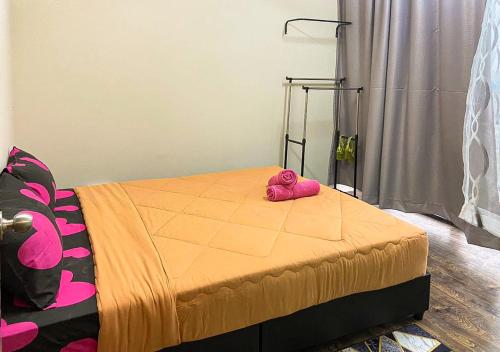 a pink stuffed animal sitting on top of a bed at HOSTEL BLACK88 Airport Transit - Self check in in Sepang