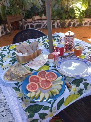 a table with a plate of food on it at Open Air Café & Apartment 1 in Port Louis