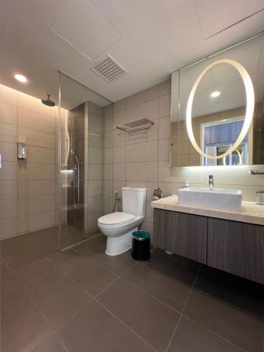 a bathroom with a toilet and a sink and a mirror at QUINCE HOME GRAND ION DELEMEN GENTING HIGHLANDs in Genting Highlands