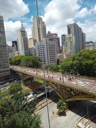 a bridge over a street in a city with buildings at Loft 37 Centro histórico in Sao Paulo