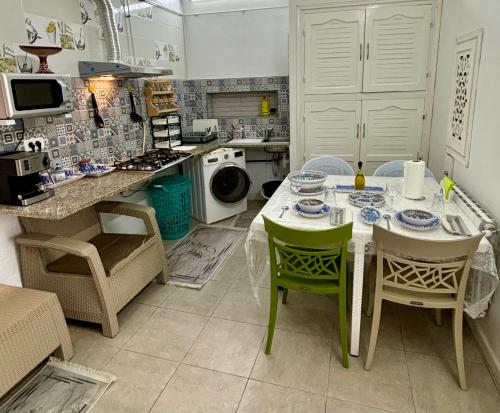 a kitchen with a table and chairs in it at MAHDIA BORJ ERRAS (CAP AFRICA) in Mahdia