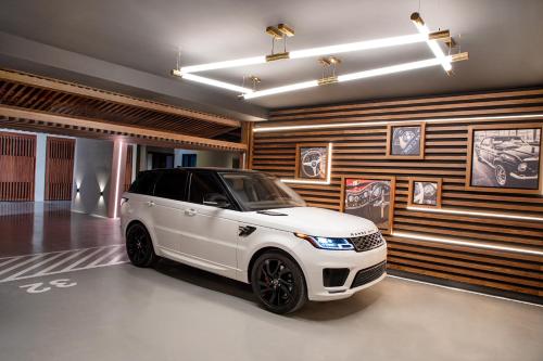 a white car is parked in a garage at The Biltmore Hotel Villas, Dubai in Dubai