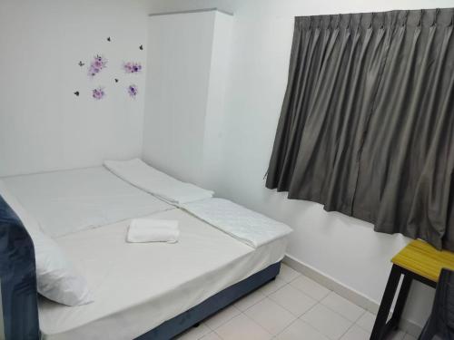 a bedroom with a bed and a window with snowflakes at CMN Hotel & Homestay in Sungai Petani