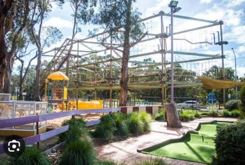 a roller coaster in a park with a playground at Ocean Reach Cape Woolamai in Cape Woolamai