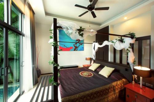 a bedroom with a bed and a ceiling fan at Вилла с бассейном на Най Харн, 2 спальни G3 in Rawai Beach