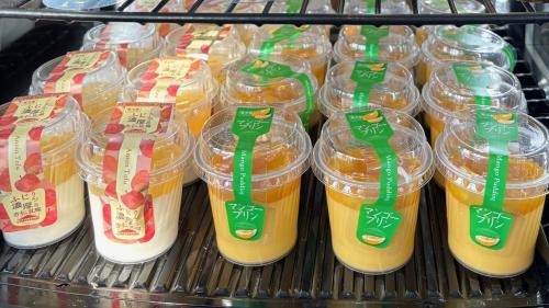 a refrigerator filled with plastic containers of orange juice at Chateraise Hotel Nagano in Nagano