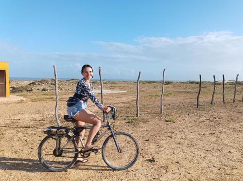 Una donna in bicicletta nel deserto di El Kachi Hospedaje y Restaurante a Uribia