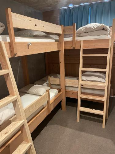 a group of bunk beds in a room at Nawate Guesthouse in Matsumoto