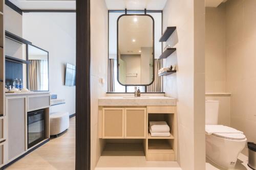 a bathroom with a sink and a mirror at Estella Khao Yai in Khao Yai
