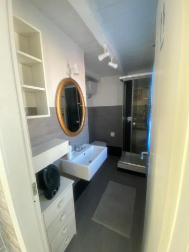 a bathroom with a white sink and a mirror at La casa di Leila in Passoscuro