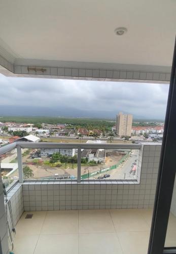 a view of a city from a window in a building at Apartamento Vila Tupi in Praia Grande