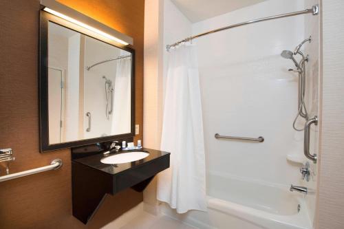 a bathroom with a sink and a shower and a mirror at Fairfield Inn Huntsville in Huntsville