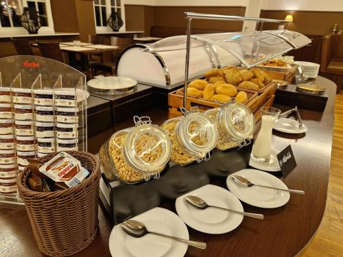 a buffet with plates and utensils on a table at Halber Mond in Heppenheim an der Bergstrasse