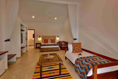 a living room with a couch and a table at Mnarani Beach Club in Kilifi