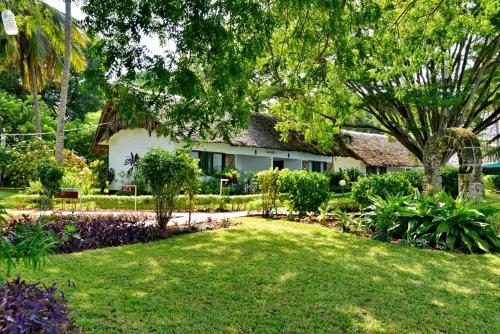 a house with a garden in front of it at Mnarani Beach Club in Kilifi