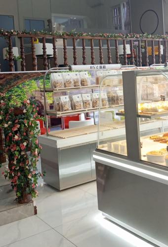 a display case in a bakery with cakes and desserts at Dansavanh Hotel in Muang Xai