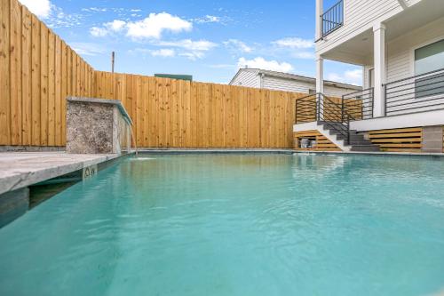 a swimming pool in a backyard with a wooden fence at New 4 Bed luxury house w/Private Heated Pool in New Orleans