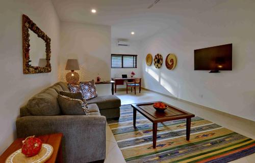 a living room with a couch and a table at Mnarani Beach Club in Kilifi
