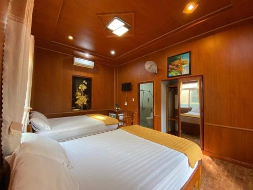a large bedroom with two beds and a bathroom at Mayfair Valley in Phú Quốc