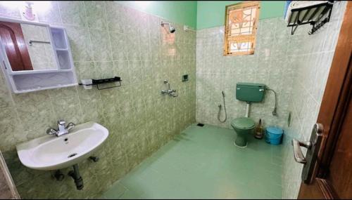 a bathroom with a sink and a toilet at La Des Chateau Holiday Suites in Majorda