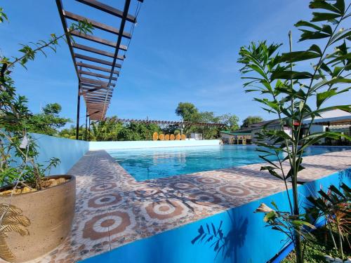 a view of a swimming pool in a villa at Yemaya de Laiya powered by Cocotel in Biga