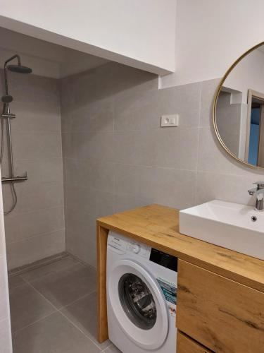 a bathroom with a washing machine and a sink at Apartma BALC in Koper