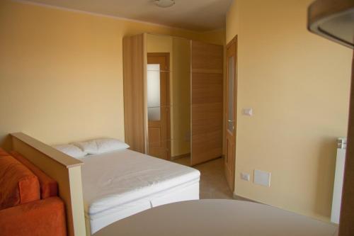 a small bedroom with a bed and a closet at Betulle 2F in Leinì