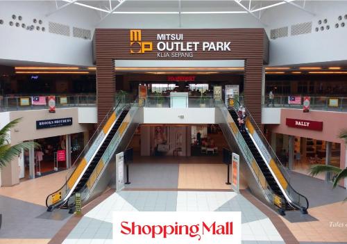 an empty mall with an escalator in a shopping mall at HOSTEL BLACK88 Airport Transit - Self check in in Sepang