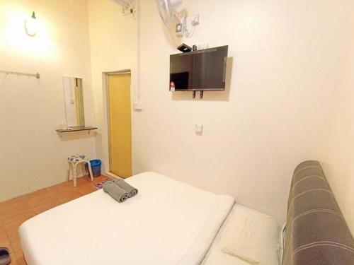 Pokój szpitalny z łóżkiem i telewizorem na ścianie w obiekcie The Tudor Home Inn 2 w mieście Brinchang