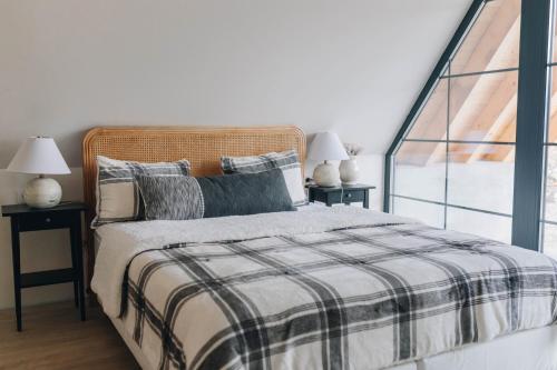 a bedroom with a bed and two tables with lamps at Hilltop Munteni in Munteni
