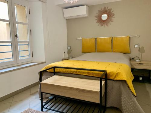 1 dormitorio con 1 cama con sábanas amarillas y ventana en Bel appartement 4 étoiles Centre Historique Toulon en Toulon