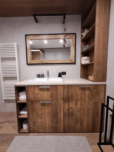 a bathroom with a sink and a mirror at Alpen Lodge Premium Apartment in Mezzana