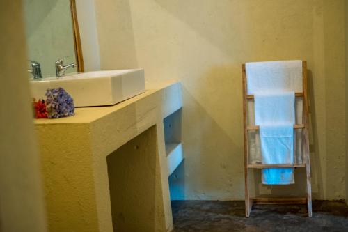 a bathroom counter with a sink and a towel rack at Rafiki Retreat in Arusha