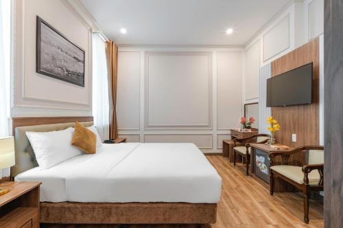 a hotel room with a bed and a desk at PINE VIEW Hotel Dalat in Da Lat