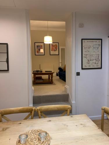a dining room with a table and a living room at The Old Bank House - Ross-on-Wye in Ross on Wye