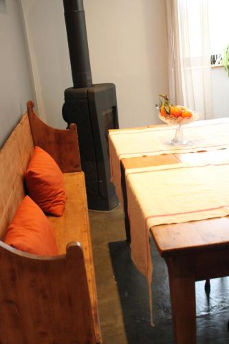 a living room with a table and a wood stove at Loft avec terrasse panoramique in Chirols