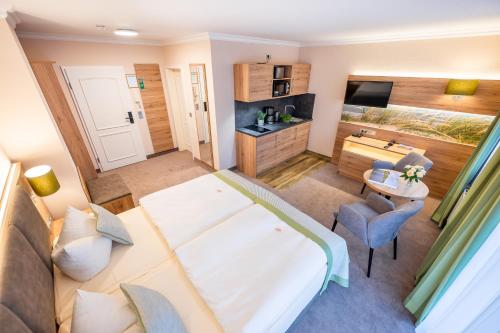 a large room with a bed and a television at Centralhotel Binz in Binz