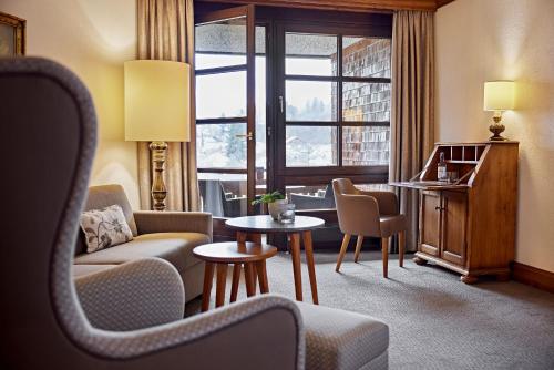 a living room with a couch and a table at Parkhotel Oberstaufen in Oberstaufen