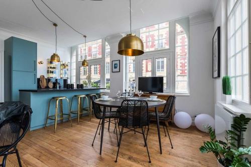 a kitchen with a table and chairs in a room at BLUE MOON KEYWEEK Seafront Apt with large Terrace and Parking Biarritz in Biarritz