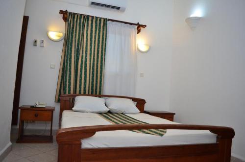 מיטה או מיטות בחדר ב-HOTEL AKBAR